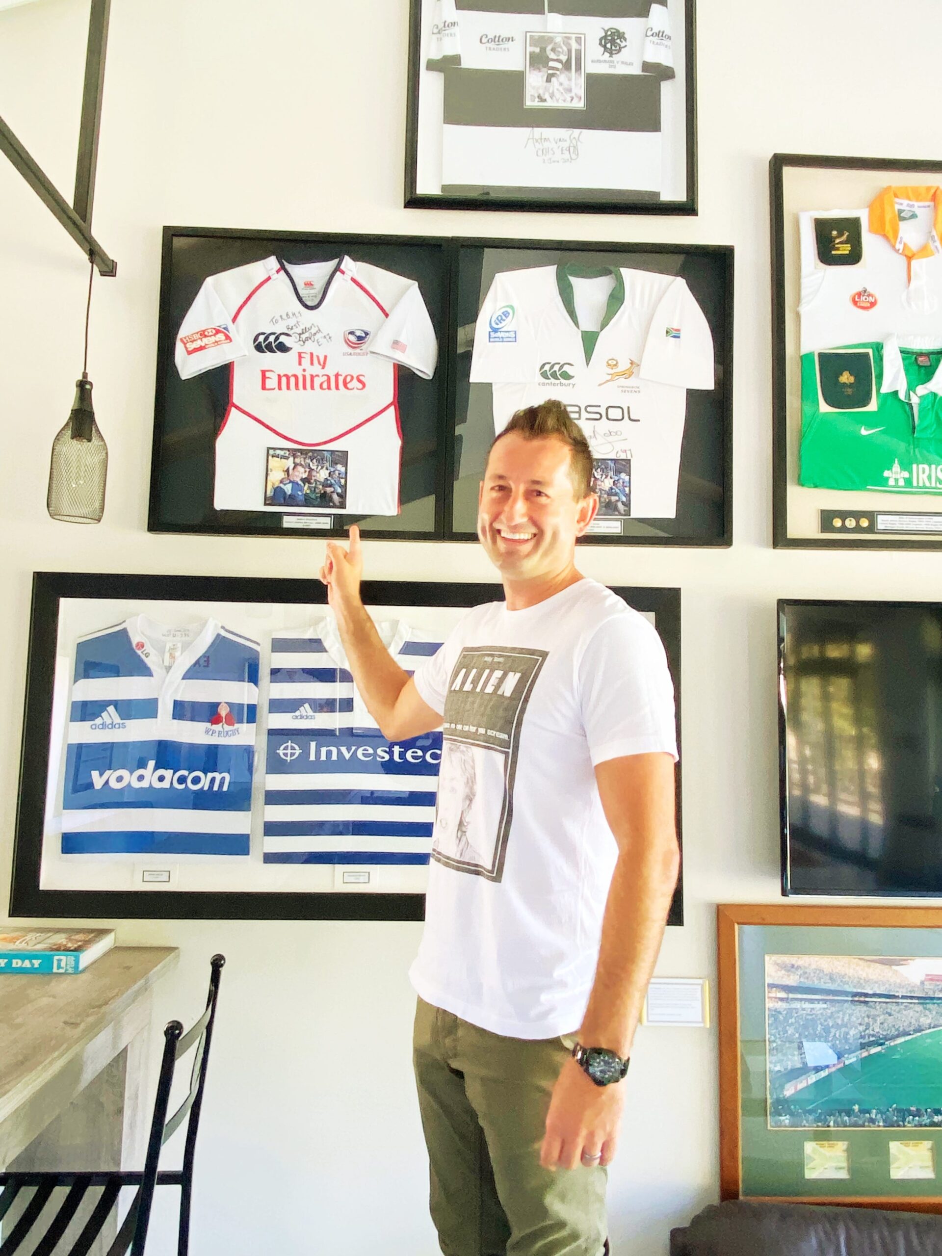 Dallen Stanford with framed rugby jerseys