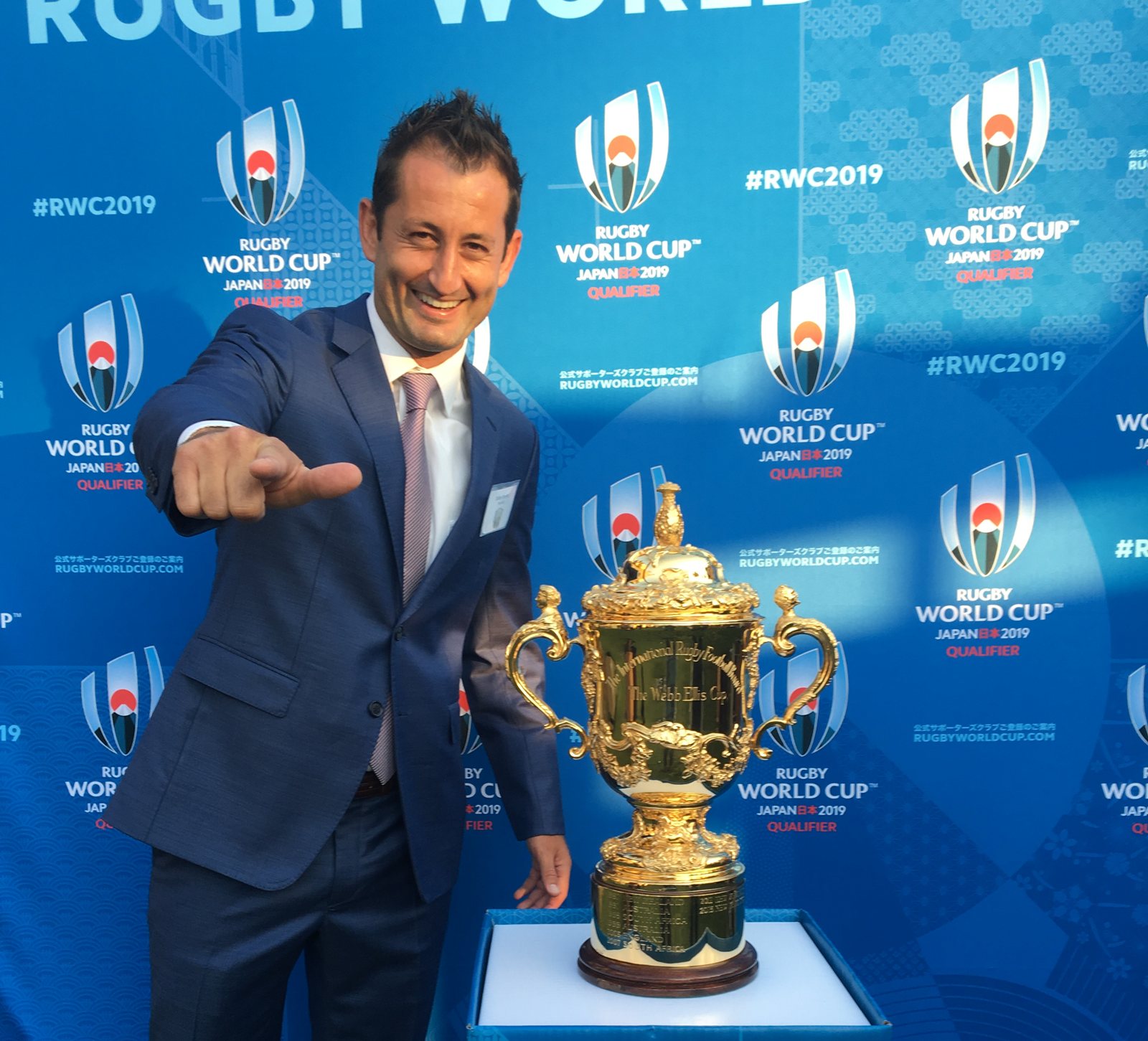 Rugby World Cup commentator Dallen Stanford with the Webb Ellis Cup at the Rugby World Cup 2019 Qualifiers for Japan