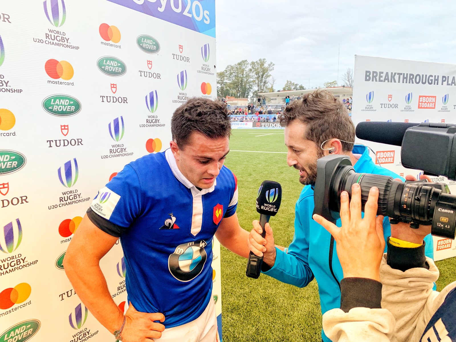 Dallen Stanford interviewing a France player pitchside as a sideline reporter at the World Rugby U20 Championship